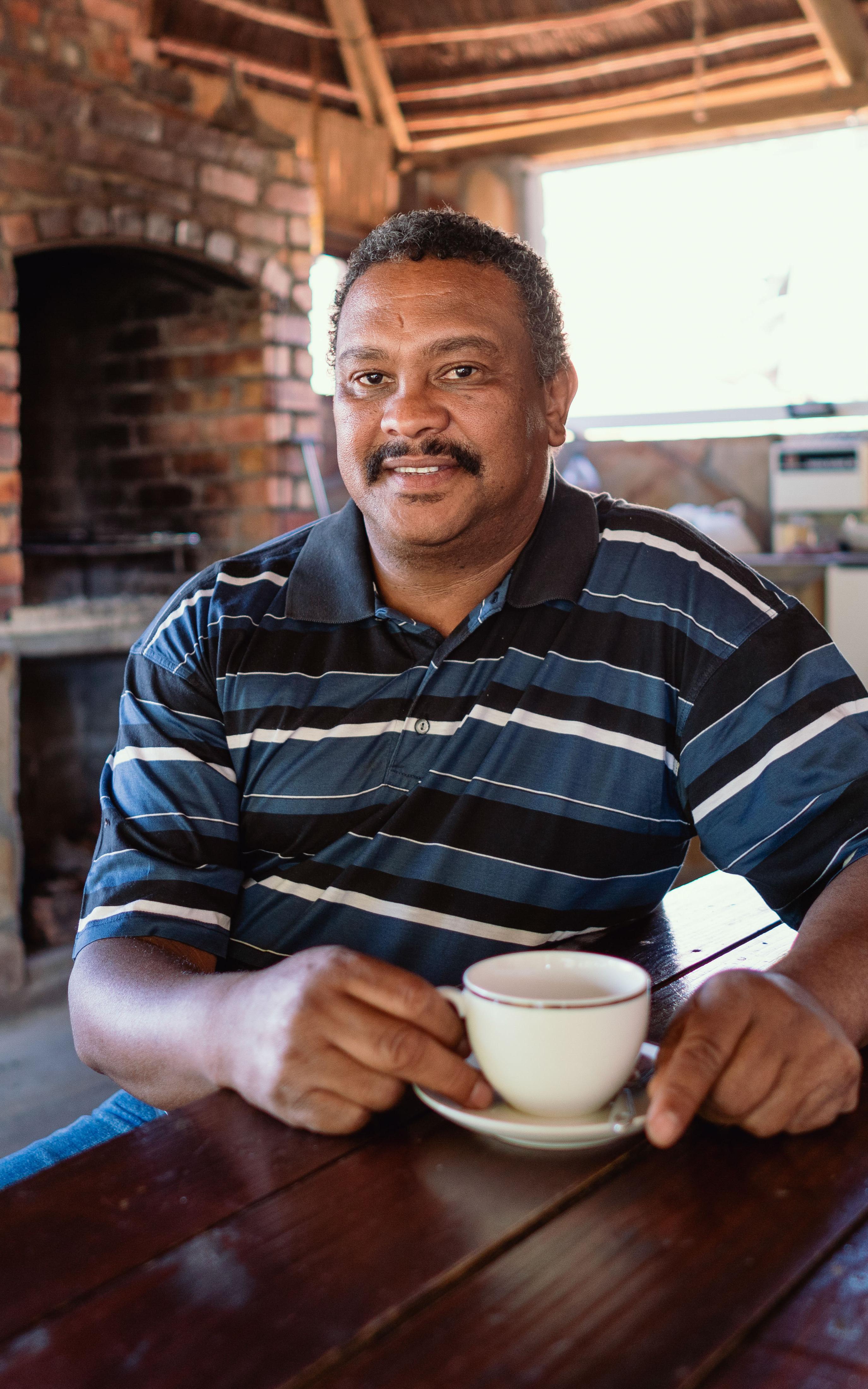 Beautiful News-Man witting with a cup of tea.