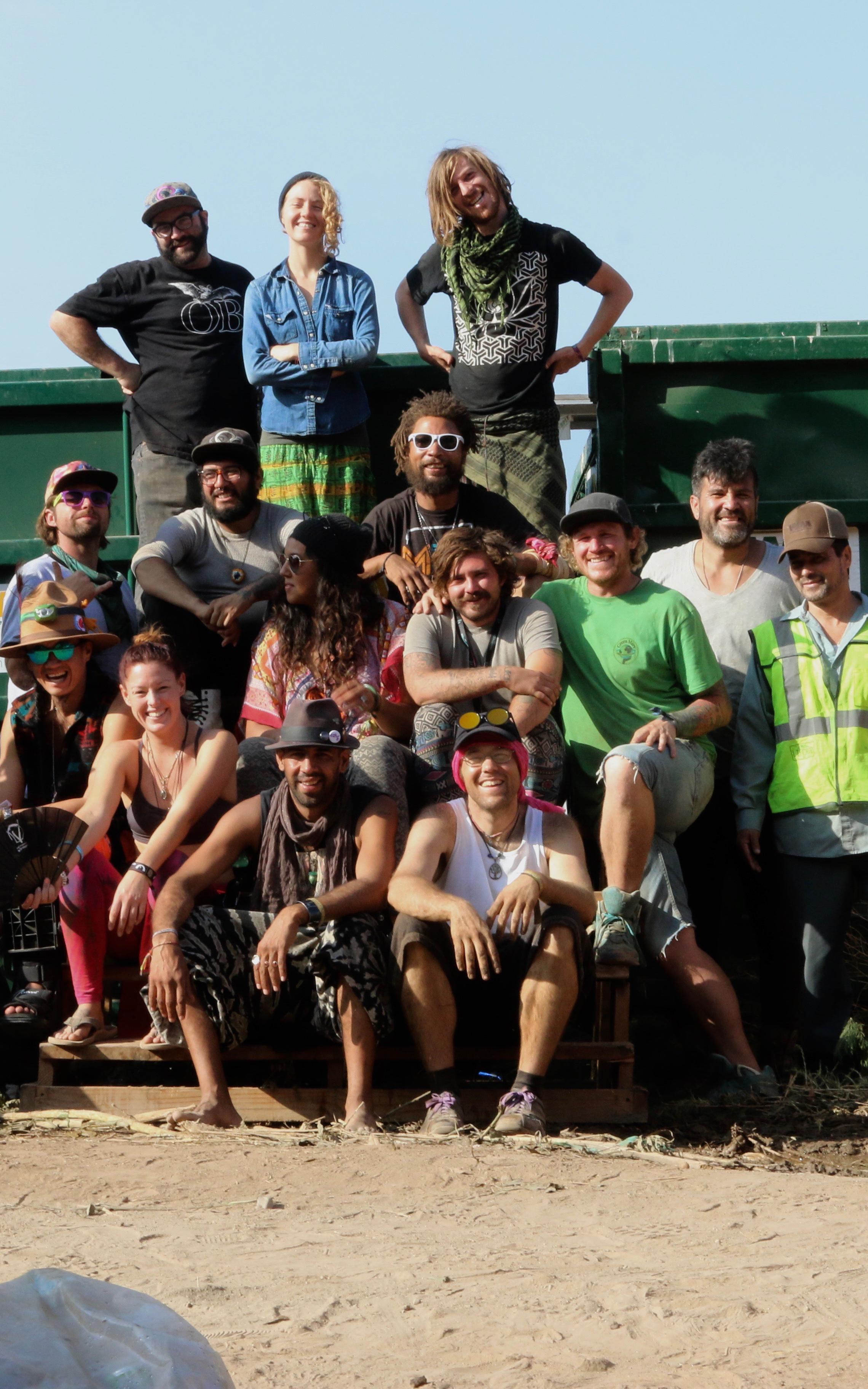 Beautiful News-People in front of waste truck.