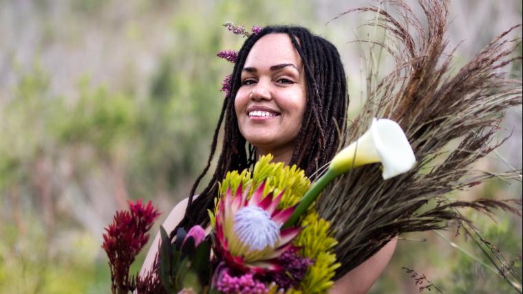 woman posing with flowers