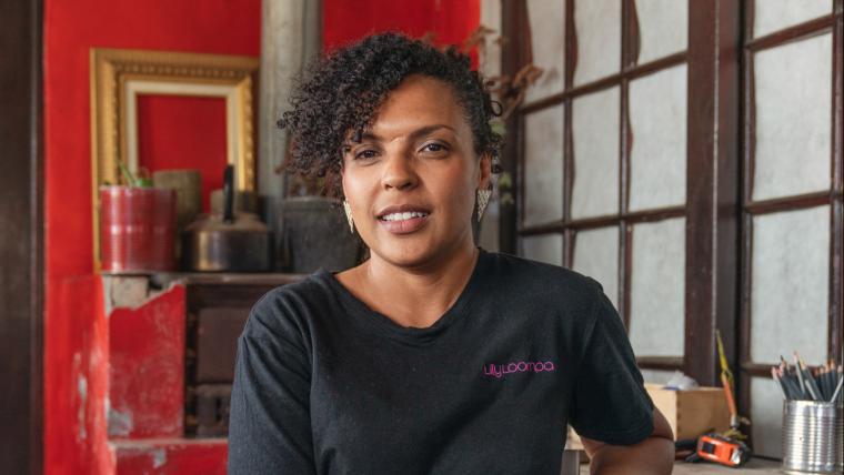 Coloured woman smiling into camera.