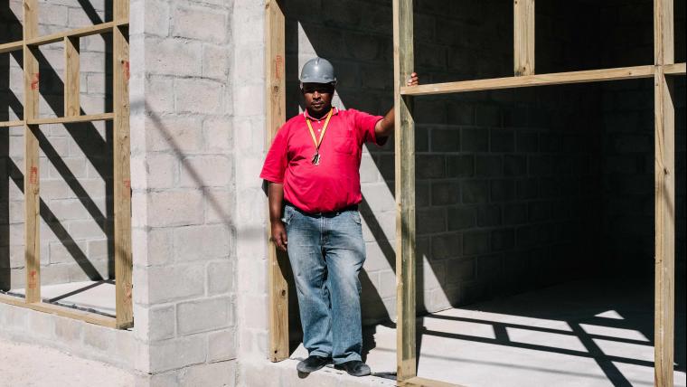 Builder standing at construction site