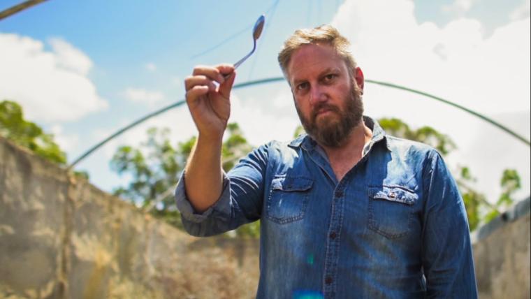 Man holding bended spoon
